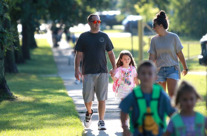 Paige and Mike Martino walk their daughter, Genevieve, to her first day of kindergarten on Friday, Aug. 16, 2024 at Kingsley Elementary School in Downers Grove.