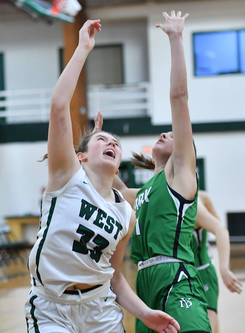 Glenbard West's Makenna Yeager (33) reacts as she sees her winning basket go in to end the game on Jan. 22, 2024 at Glenbard West High School in Glen Ellyn.