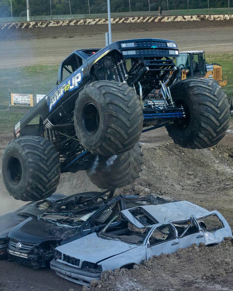 Driver of the Monster Truck 'Amp'ed Up' flies over 3 cars and ramp at the Monster Truck Bash on Saturday, Sept. 13, 2025 at the La Salle Speedway in La Salle.