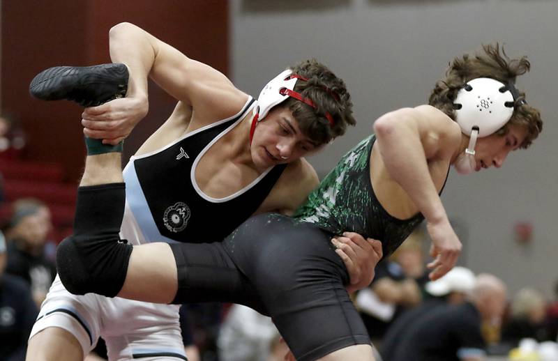 Marian Central’s Nick Marchese  tries to take down North Boone’s Gavin Ekberg in the 126-pound championship match of the IHSA 1A Marengo Wrestling Regional on Saturday, Feb. 8, 2025, at Marengo High School.