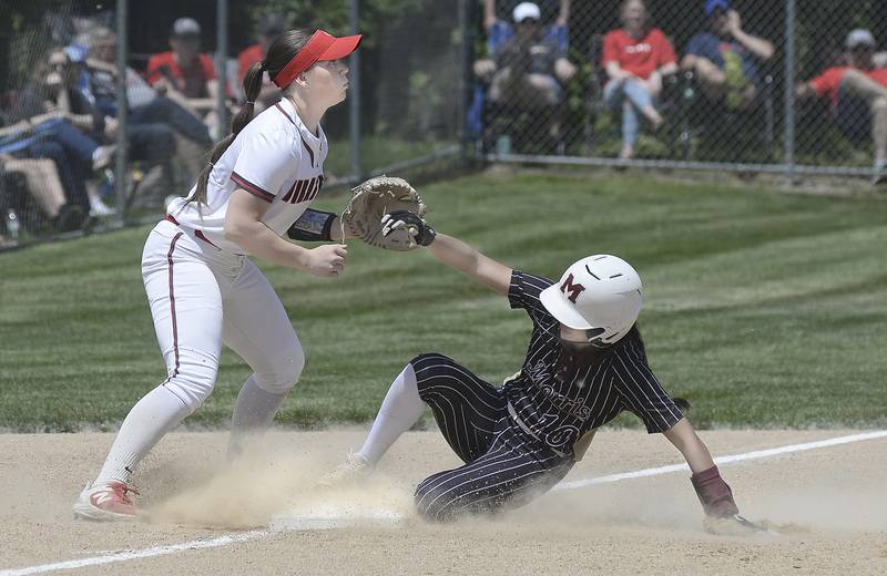 As Ottawa’s Maura Condon (at left) awaits the throw at third, Morris’ Elaina Vidales slides in safely with a triple during the opening inning of their Class 3A regional title game Saturday, May 27, 2023, at Ottawa High School.
