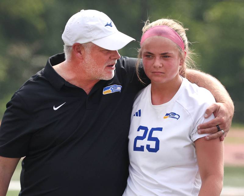 Johnsburg Head Coach Rob Eastland comforts Jacquelyn Douglas Saturday, June 7, 2025, after their IHSA Class 1A state championship loss to Columbia at North Central College in Naperville.