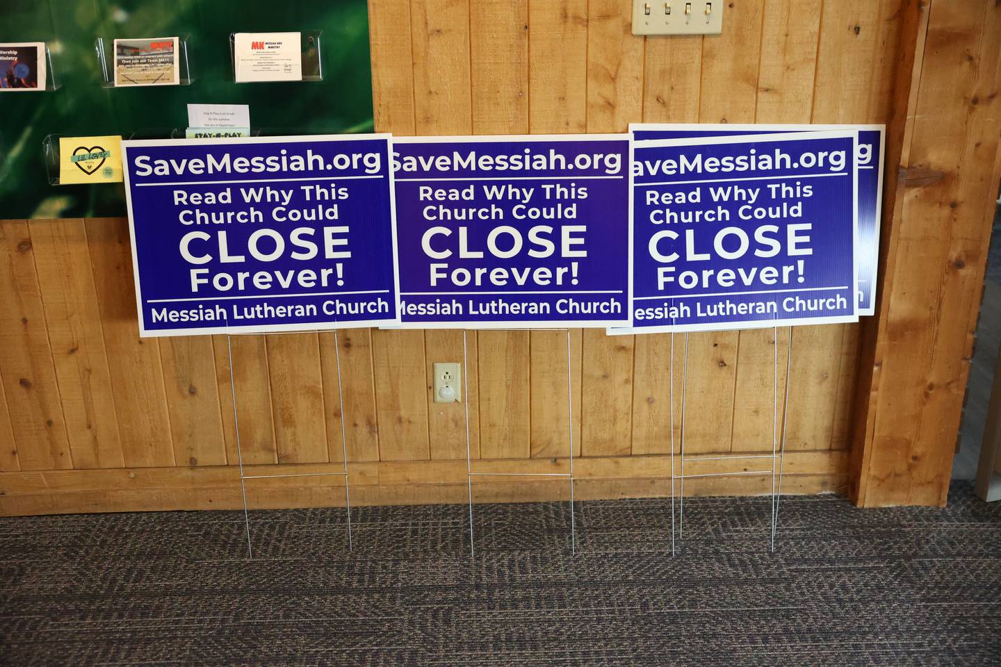 Yard signs to save Messiah Lutheran sit in the lobby at a press conference on Thursday, Sept. 7, 2023 at the church in Joliet. As a result of a lawsuit by the Security and Exchange Commission for fraudulent financial dealings by a local company, Messiah Lutheran is required to pay back $487,000 of the $780,000 that was donated over a 10-year period to the church by this local business.