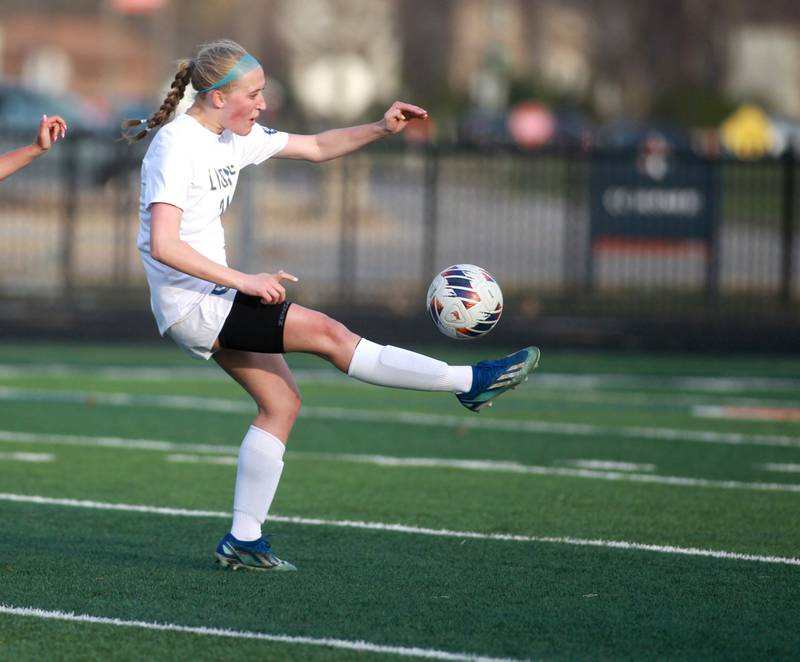 Lyons Township's Avery Lusk kicks the ball during a game against Naperville North on Wednesday, April 16, 2025 in Naperville.