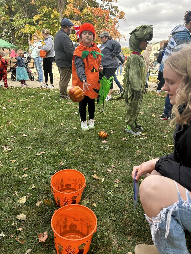 Paisley Waymare, 9, of the state of Ohio,, plays a game at the Evangelical Free Church of Mt. Morris Trunk or Treat held in conjunction with the Fall Family Festival in Mt. Morris on Sunday, Oct. 13, 2024. Paisley was in town visiting relatives.