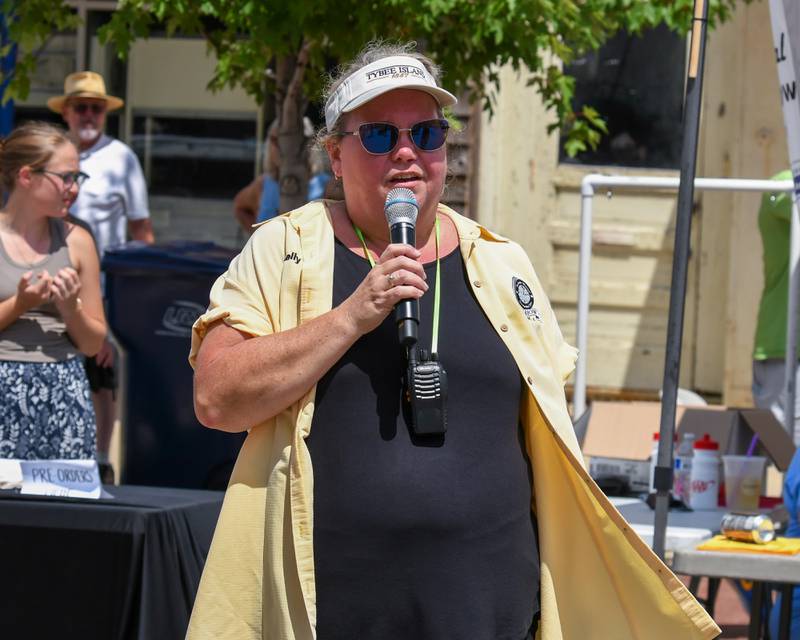 Kelly Kuhn speaks during the opening ceremony of the Fizz Ehrler Memorial Turning Back Time Car Show on Sunday, July 27, 2025, held in downtown Sycamore.