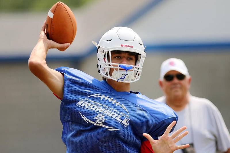 Dundee-Crown quarterback Josh Raby warms up during practice Aug. 13.