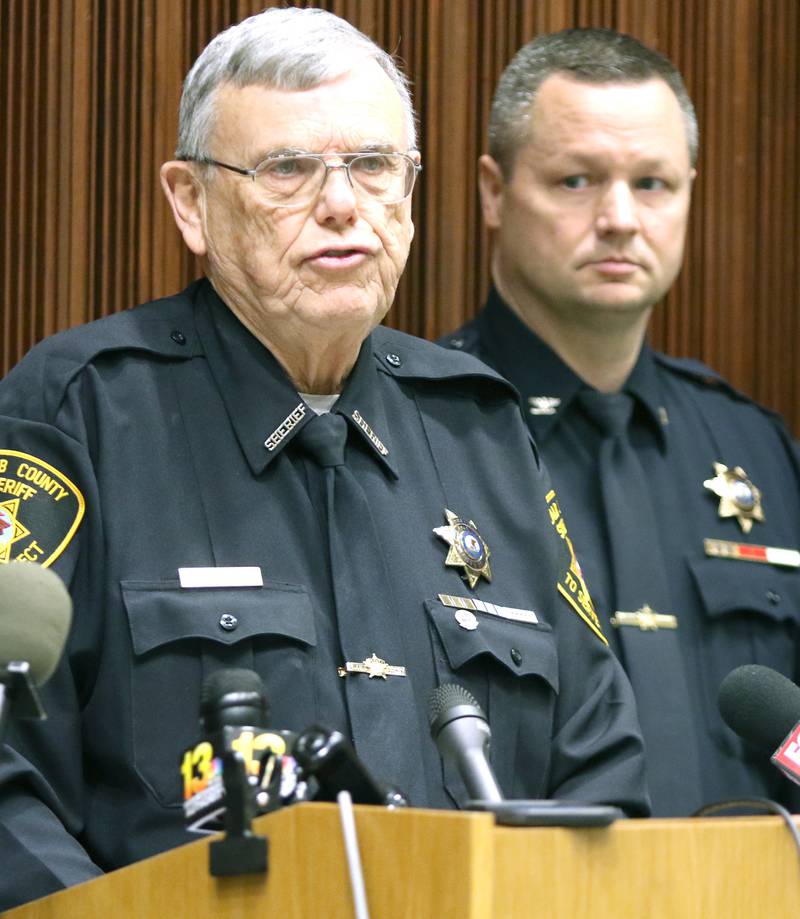 DeKalb County Sheriff Roger Scott speaks as Chief Deputy Andy Sullivan looks on Tuesday during a press conference announcing the arrest of Jonathan D. Hurst on charges of first degree murder in the killing of Patricia and Robert Wilson of Sycamore.