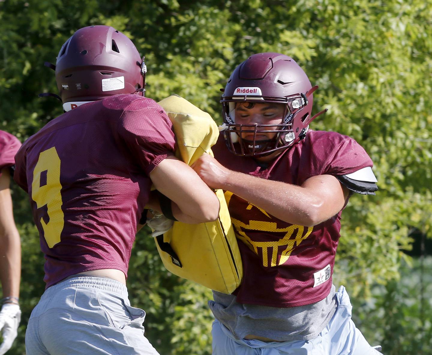 Richmond-Burton’s Braxtin Nellessen (right) fights through the block of Daniel Kalinowski during summer football practice Thursday, July 27, 2023, at Richmond-Burton High School in Richmond.