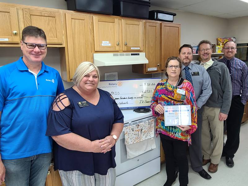 (Left to right) Illinois Valley Sunrise Rotary President Mike Dudek, First Vice President Carrie Lijewski, IV Pads Executive Director Carol Alcorn and rotarians Jason Curran, Stan Wolf and Steve Schweickert pose for a photo following the Rotary's donations to the homeless shelter.