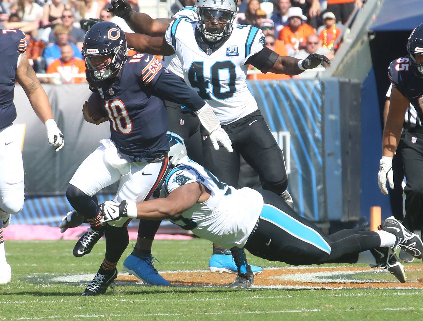 Chicago Bears quarterback Caleb Williams fights for extra yards as Carolina Panthers defensive tackle Shy Tuttle brings him down on Sunday, Oct. 6, 2024 at Soldier Field in Chicago.