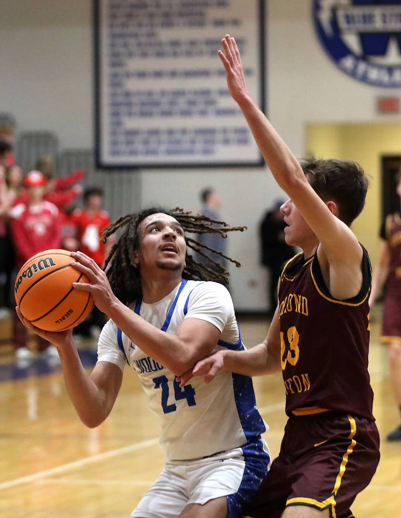 Woodstock's JJ Stokes looks to shoot the ball against Richmond-Burton's William Gardner during a Kishwaukee River Conference boys basketball game on Wednesday, February. 4, 2026, at Woodstock High School.