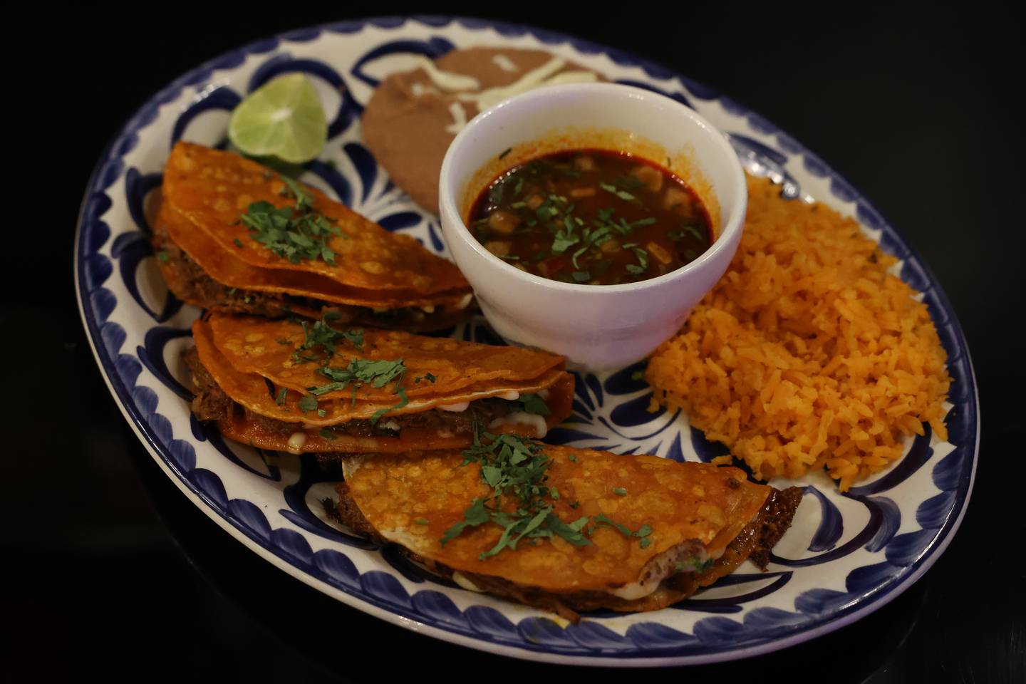 Torro in Lockport Mexican cuisine’s popular three Birria Taco Dinner, a house specialty made with beef topped with cheese, onion, and cilantro served with consome.