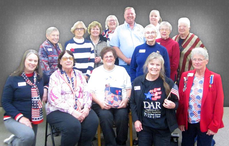 Members  of the Chief Senachwine Chapter, Daughters of the American Revolution, surround program presenter, Roger Masters, Commander of Henry's American Legion Post 323, who shared his military experiences with the group.