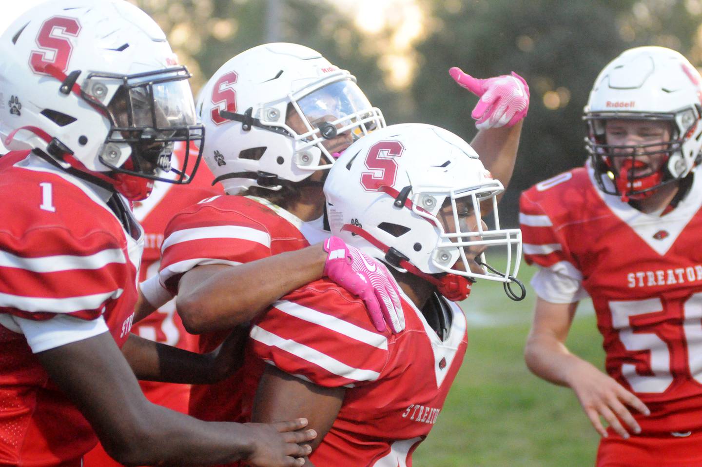 The Streator football team celebrates a Leodies Jordan (4) touchdown against Eisenhower at Doug Dieken Stadium.