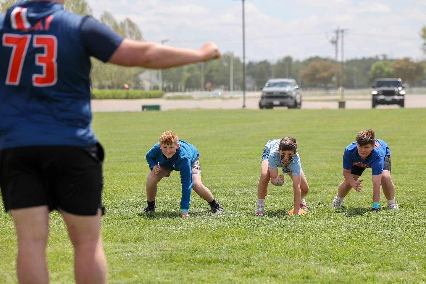 From left, Jordan Emerson, 12, Blake Hopper, 11, and Coltan Worobey, 11, wait for the start signal to race from Josh Gesky, a former Manteno High School star and current offensive lineman at the University of Illinois, during Gesky's inaugural Youth O-Line Camp at Legacy Park in Manteno on Saturday, May 17, 2025.