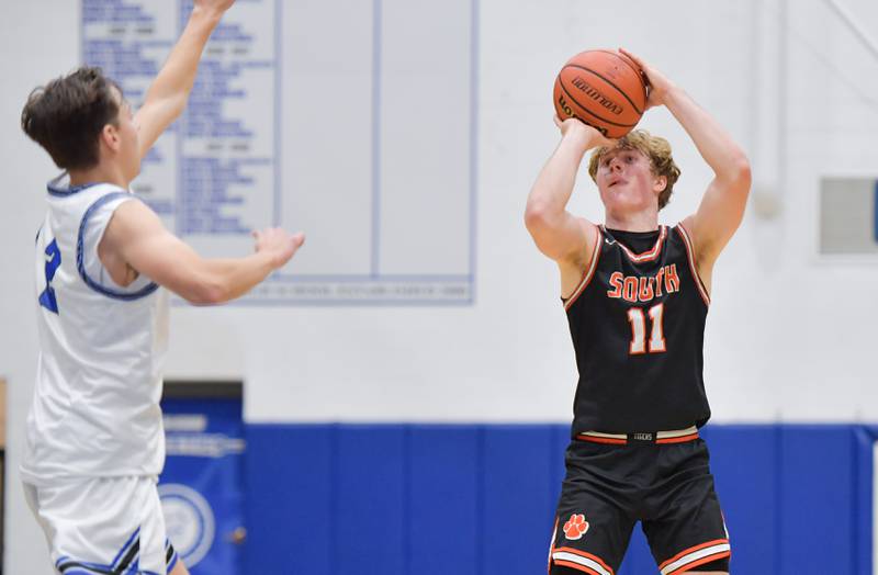 Wheaton Warrenville South Colin Moore (11) sinks a 3 point shot against St. Charles North during a game on Friday, December 2, 2022.