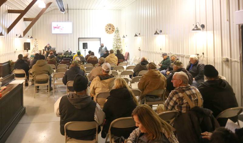 Around 50 people gathered during the Pat and Sharon Broeren auction on Saturday, Dec. 13, 2025 at Dahl Real Estate Auctions and Appraisals in Walnut. The tractor was made in the 1930's and was the oldest one of the Broeren's collection.