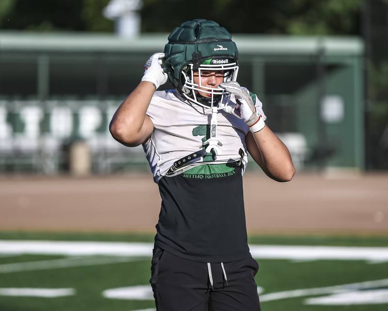 Brady Johnson adjusts his helmet at Glenbard West football practice, Wednesday, Aug 21, 2025  in Glen Ellyn.