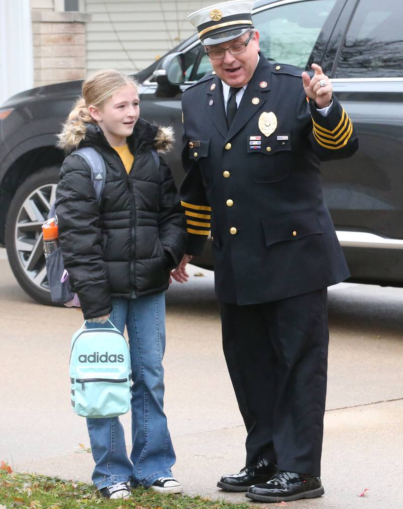 Putnam County Elementary third-grade student Octavia Walter smiles after being picked up to school by Hennepin Fire Department deputy chief Quentin Buffington in a fire engine after winning the Hennepin Fire Department Escape Floor plan contest on Tuesday, Nov. 21, 2023. Students had to draw a floor plan or map of their home showing all doors and windows. Smoke alarms had to be marked in each plan. A family meeting place was also required to be marked on the drawings. The Hennepin Fire Department has been holding the contest for several years. The department stopped the event during Covid and continued it for the first time since the pandemic this year. The department picks the winning children up on a firetruck and busses them to school.