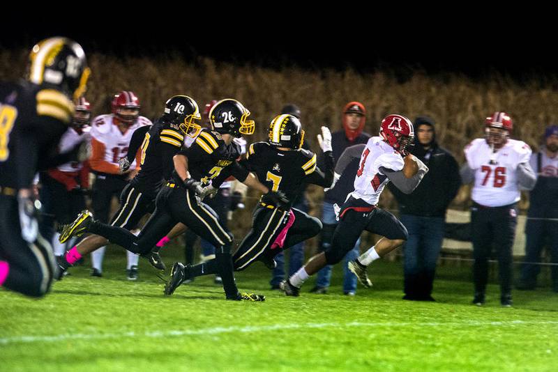 Amboy-LaMoille's Marcus Winn (3) gets to the sidelines and runs for a touchdown against AFC on Friday night at Mel Barron Field in Franklin Grove.