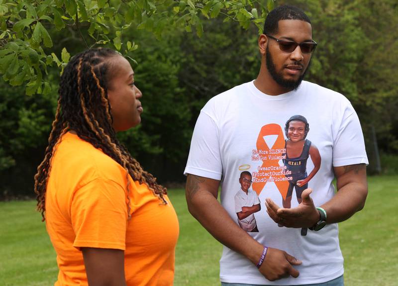 Andrea Elion, mother of Ezra Hill Jr. and Brandon Elion Ezra’s stepfather, talk about Ezra next to a tree and rock garden at Tyler Elementary School Monday, May 12, 2025, that is dedicated to the memory of Ezra, who was was murdered in 2019 in Harvey. An Ezra Hill Jr. Memorial Rock Painting event will be held on June 7 at the school in DeKalb.
