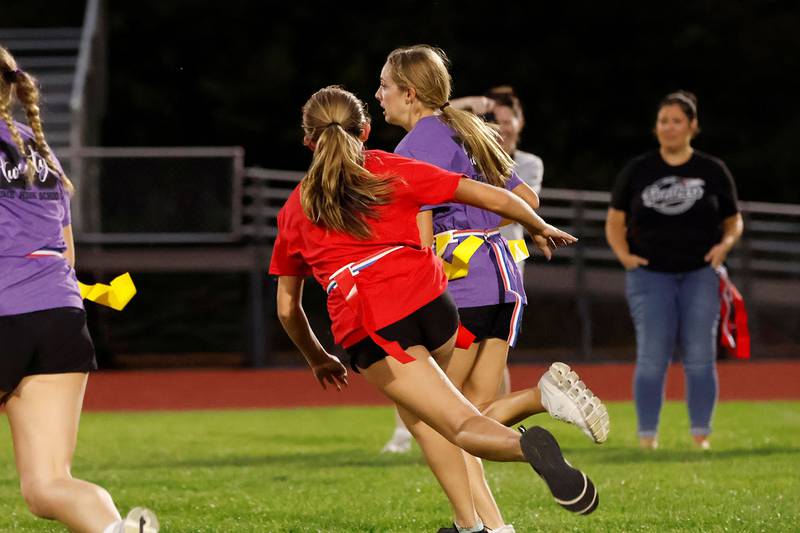 Erie High School sophomore Laila Keeling (purple) scrambled up the football field in Erie Wednesday, Oct. 1, 2025, during the EHS Powder Puff football tourney. The Freshmen, Sophomore, Junior, and Senior classes each gathered girls to represent their class in the homecoming week event. The 2025 EHS Powder Puff tournament winner was the Senior class.