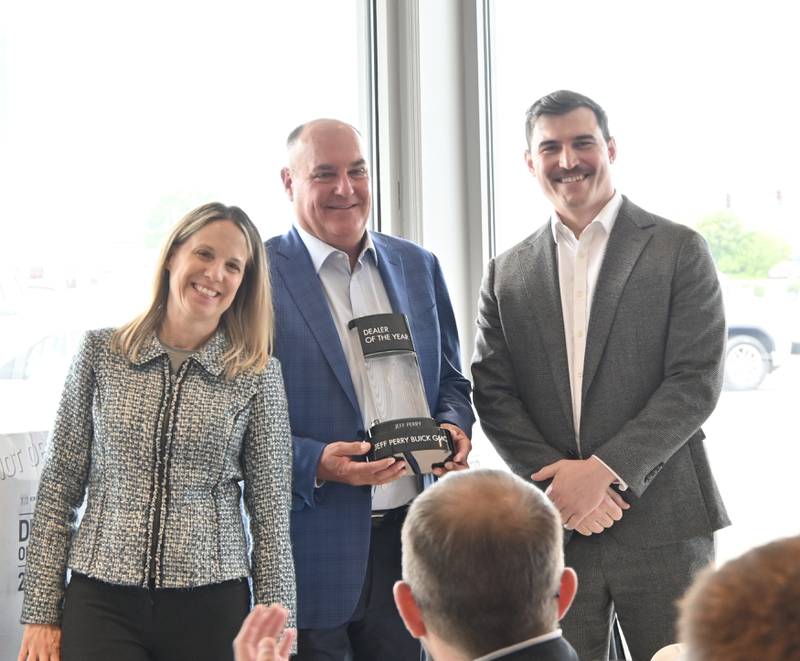 Regional Director of the North Central Region for GMC Shari Keith, Jeff Perry, and Senior Zone Manager for GMC Sean Greatrex show off the2022 Buick Dealer of the Year by General Motors on Monday June 12, 2023.