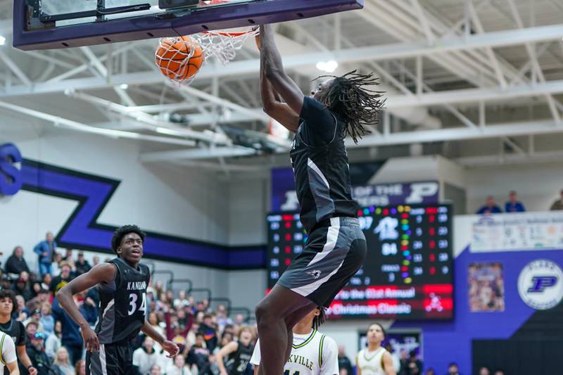 Kaneland's Freddy Hassan (5) dunks the ball off of a fast break against Yorkville Christian during a championship final basketball game in the 61st annual Plano Christmas Classic at Plano High School on Saturday, December 28, 2024.