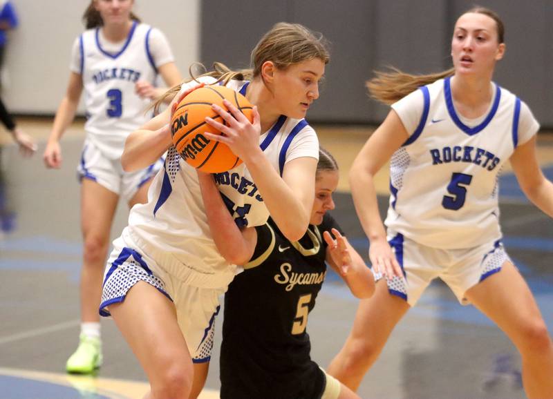 Burlington Central’s Scarlett Lafleur, left, battles Sycamore’s Grace Amptmann for the ball in girls basketball at Burlington Central High School in Burlington on Tuesday, November 18, 2025.