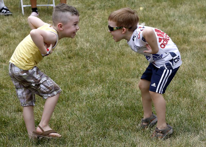 Best friends Logan Crumpley, 5, and Greyson Michalski. 4, play a game while waiting to compete in the ice cream contest during Lakeside Festival Friday, June 30, 2023, at the Dole and Lakeside Arts Park in Crystal Lake.