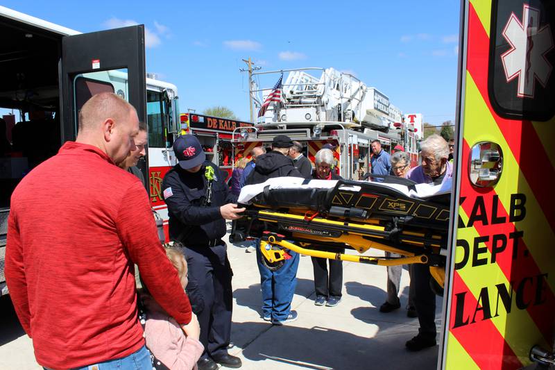 Community members watch a demonstration at one of the ambulances on display outside DeKalb Fire Station No. 4 at 1130 S. Malta Road at a grand opening event on Saturday, April 26, 2025.