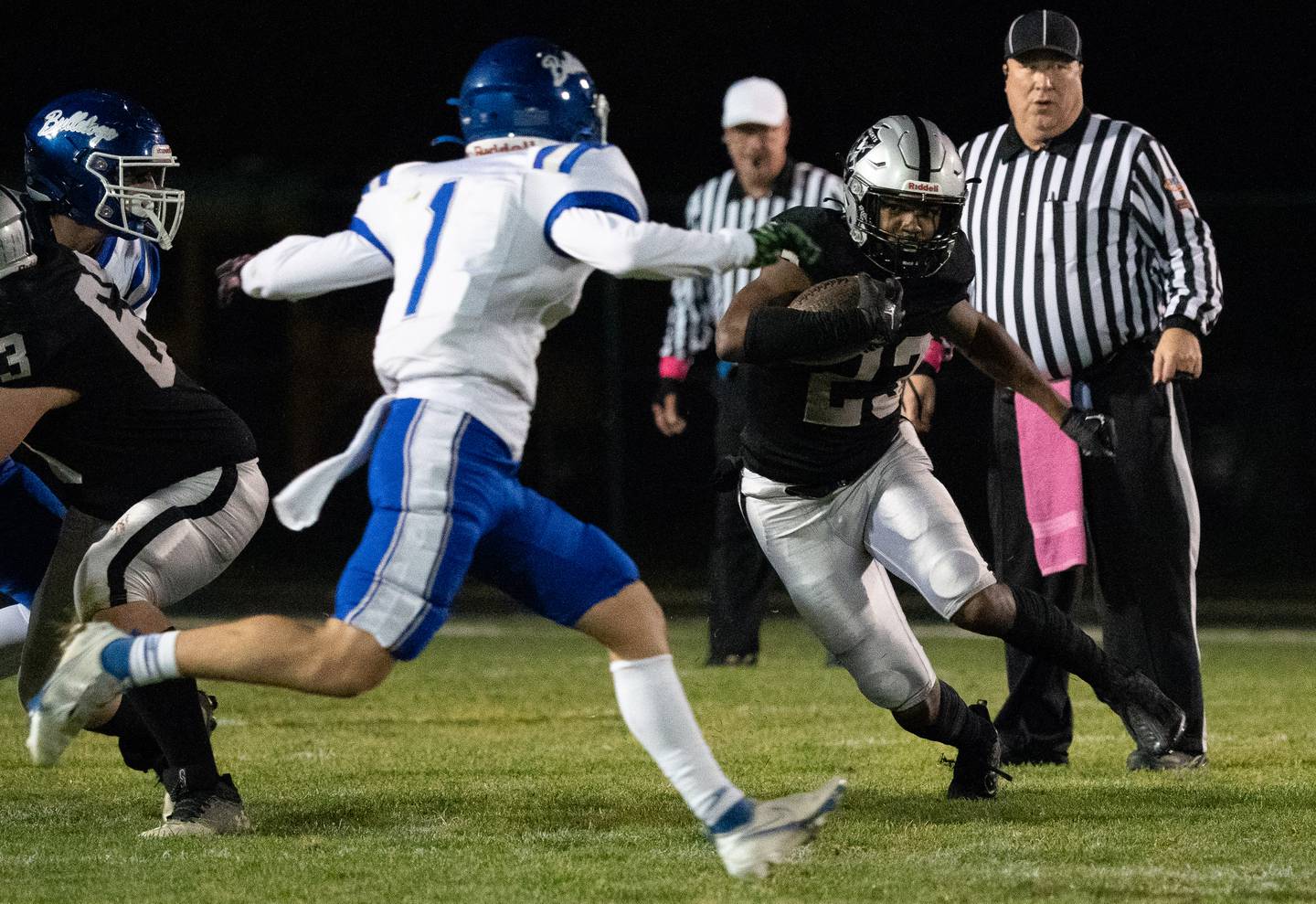 Kaneland’s Aric Johnson (23) carries the ball against Riverside Brookfield during a 6A playoff football game at Kaneland High School in Maple Park on Friday, Oct 28, 2022.\