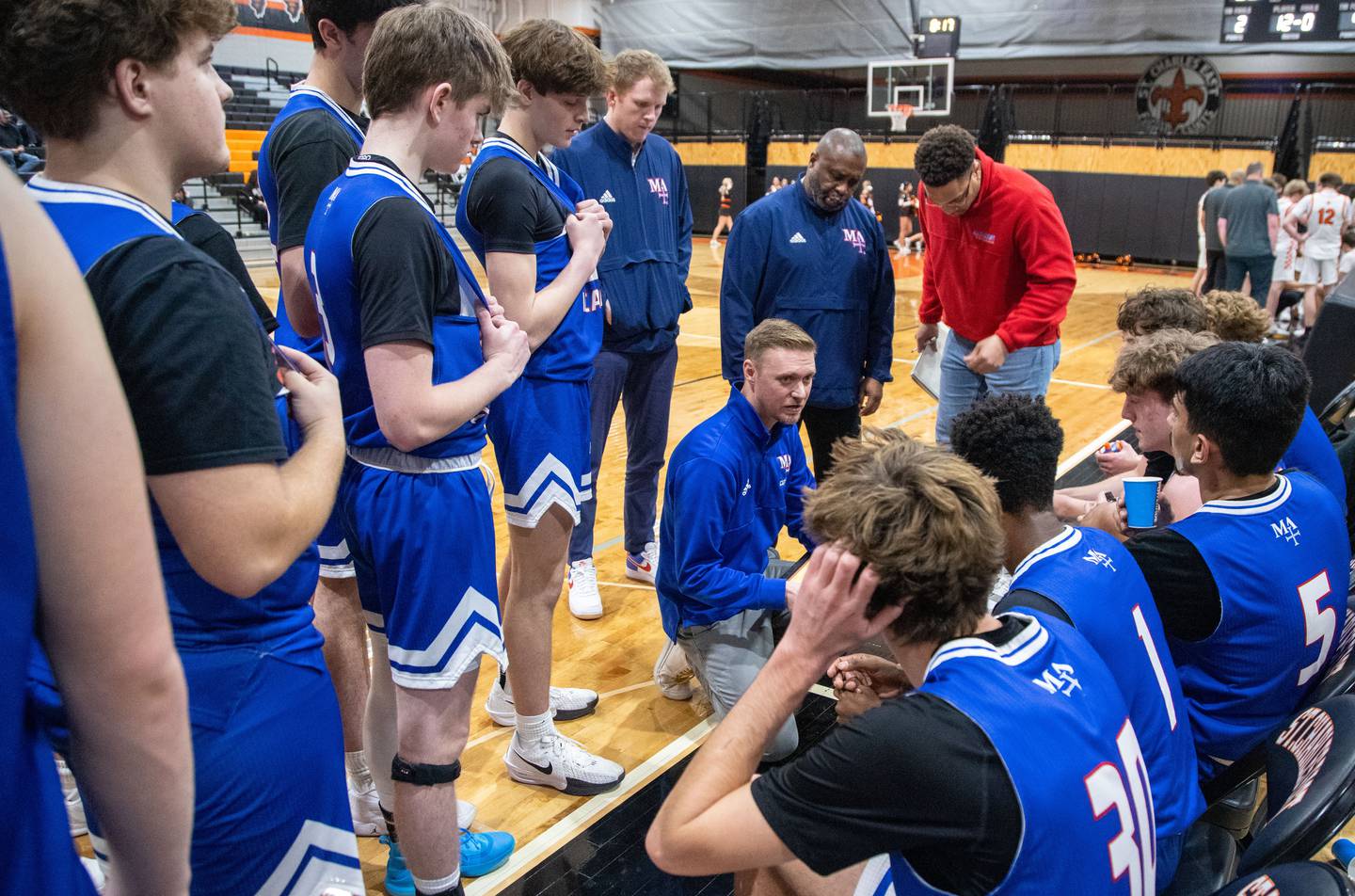 Marmion Academy head coach Joe Piekarz makes a game plan with his team before the fourth quarter during a game against St. Charles East on Saturday, Jan. 4, 2025.