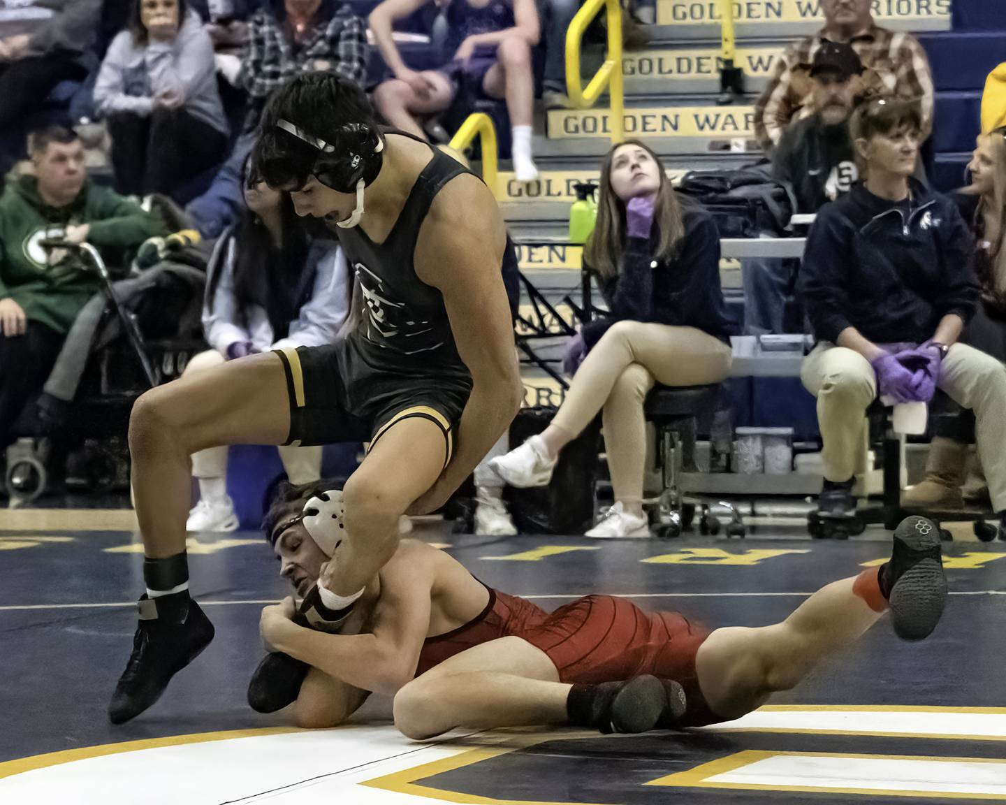 Erie-Prophetstown's Wyatt Goossens (bottom) grabs the leg of Galesburg's Gauge Shipp during their 126-pound title bout at the 44th annual Carson DeJarnatt Tournament on Saturday, Dec. 3, 2022 at Musgrove Fieldhouse in Sterling.