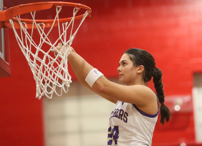 Serena's Paisley Twait cuts a piece of the net down after defeating Ashton-Franklin Center in the Class 1A Earlville Regional on Thursday, Feb. 15, 2024.