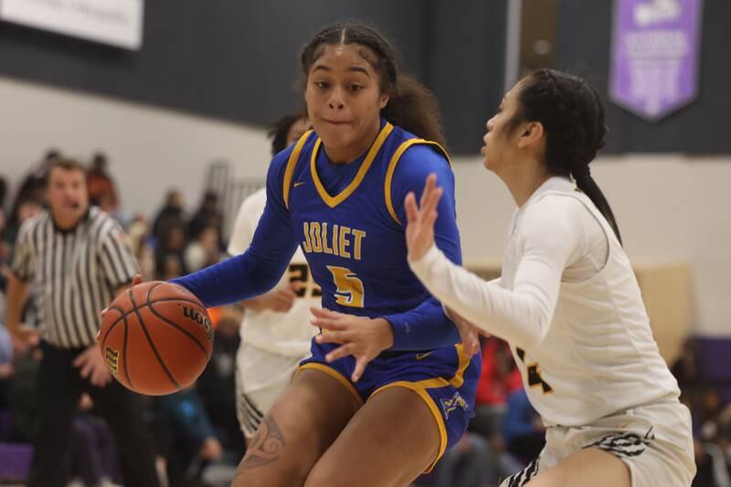 Joliet Central’s Joyce Tua-Link makes a move to the basket against Joliet West at Joliet Junior College.