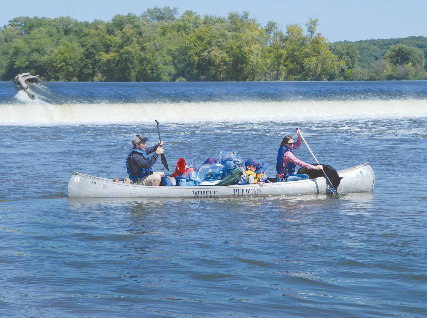 Chris and Laura Gradoski, of West Chicago, paddle their canoe with Milo and Noah, and July their dog, from the White Pelican entry point below the Oregon dam in 2017. The family was headed to the canoe campground at Castle Rock State Park.