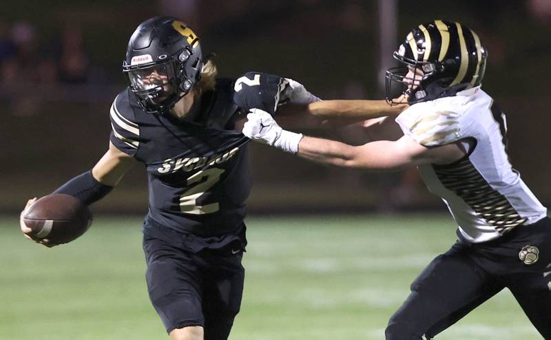Sycamore's Elijah Meier attempts to fend off the tackle of Oak Forest's Joe Castaneda during their game Friday Sept. 2, 2022, at Sycamore High School.