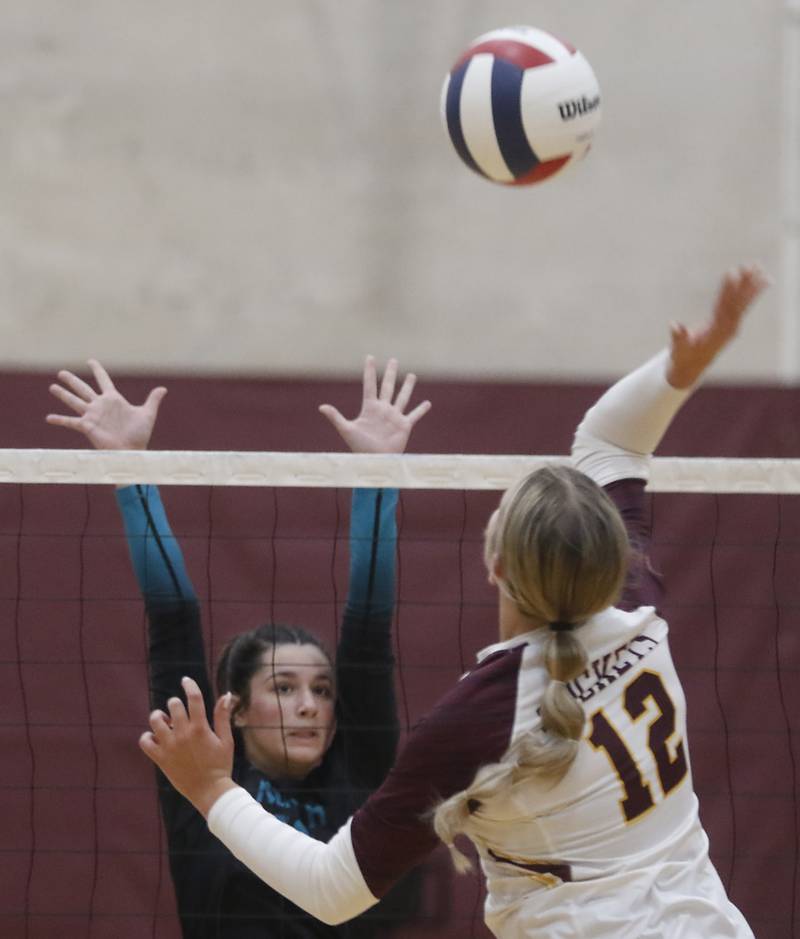 Woodstock North's Ava Kardaras tries to block the spike of Richmond-Burton's Zoe Freund during a Kishwaukee River Conference volleyball match on Wednesday, Oct. 15, 2025, at the Richmond-Burton High School in Richmond.