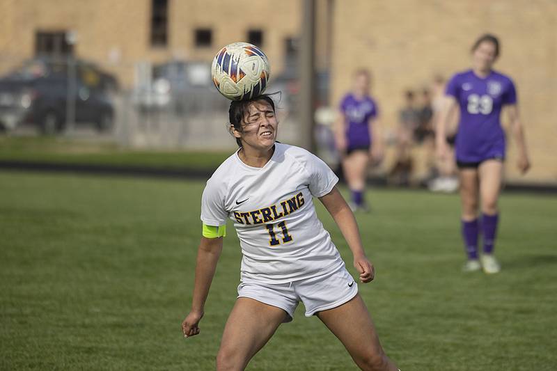 Sterling’s Maria Garcia heads the ball upfield against Dixon Tuesday, May 9, 2023.