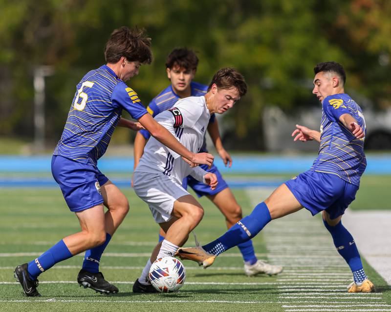 Downers Grove North's Will Beatty (4) is surrounded by the Lyons defense during Class 3A Lyons Regional final soccer match.  Oct 21, 2023.
