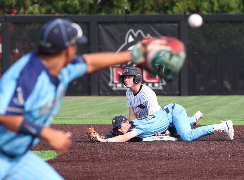 Marquette's Griffin Dobberstein (bottom) and Fulton's Jacob Huisenga watch to see the call at first after Dobberstein forced out Huisenga on the double play attempt Monday, June 2, 2025, during their Class 1A supersectional game at Northern Illinois University in DeKalb.