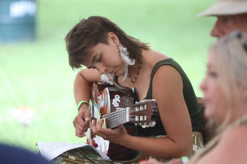Olivia Kics, working on her music degree at Joliet Junior College, attends the Intro to Slide Guitar workshop at the Gebhard Woods Dulcimer & Traditional Music Festival on Saturday June 8, 2024 in Morris.