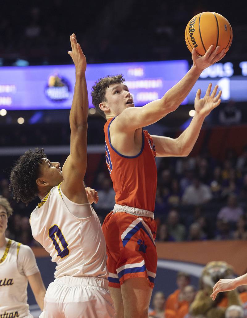 Eastland’s Peyton Spears puts up a shot over Peoria Christian’s Trae Brickner Thursday, March 13, 2025, during the Class 1A boys basketball state semifinal.