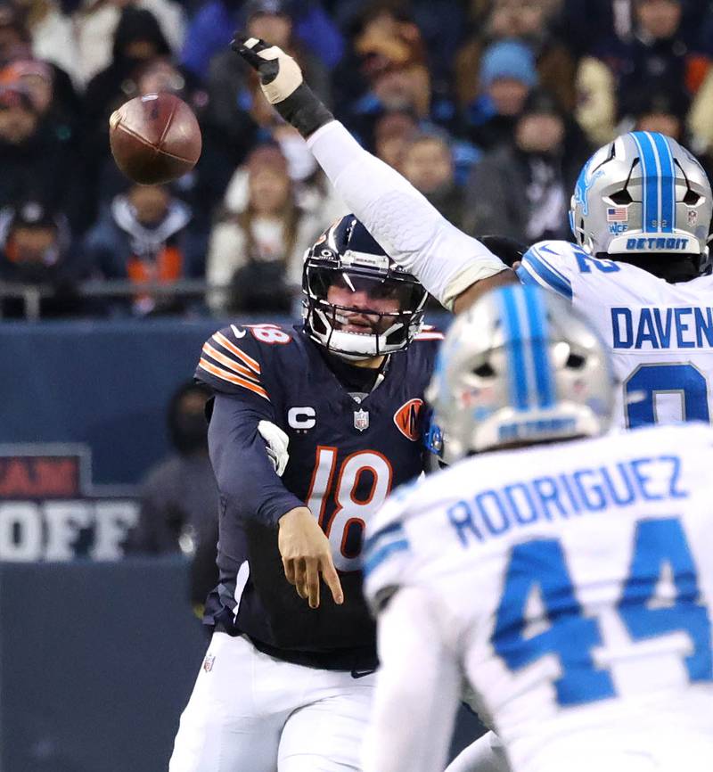 Chicago Bears quarterback Caleb Williams throws the ball by Detroit Lions defensive end Marcus Davenport during their game Sunday, Jan. 4, 2026, at Soldier Field in Chicago.