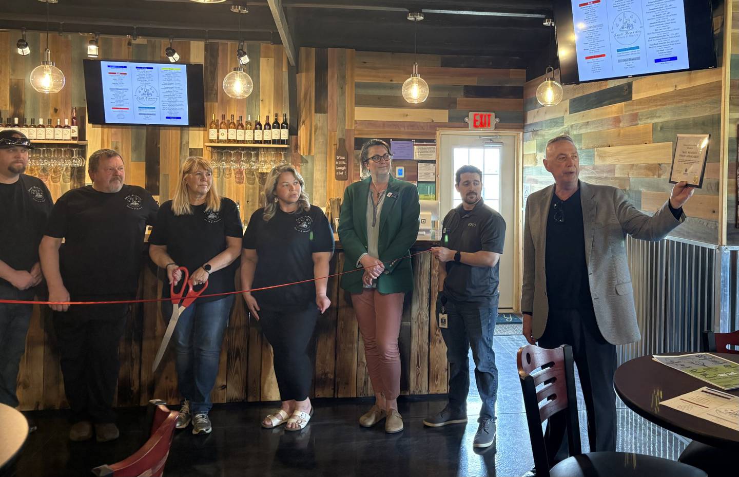 Ottawa Area Chamber of Commerce Executive Director Jay McCracken presents a plaque to the Small family on behalf of the chamber, just before the ribbon-cutting ceremony at Small Memories Meadery and Winery on Friday, May 2, 2025.