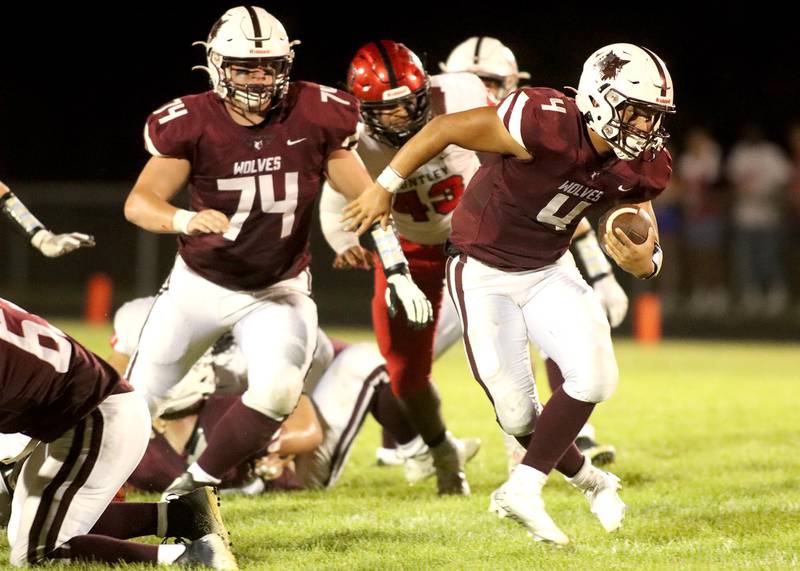 Prairie Ridge’s Nathan Greetham, right, looks for running room as teammate Henrik Nystrom, left, follows the play against Huntley in football Friday night at Crystal Lake
