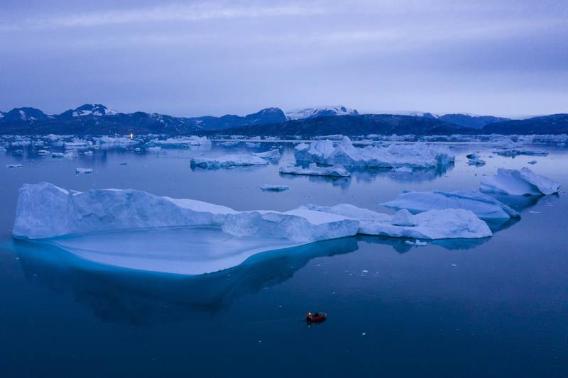 FILE - A boat navigates large icebergs near the town of Kulusuk, in eastern Greenland, on Aug. 15, 2019. (AP Photo/Felipe Dana, File)