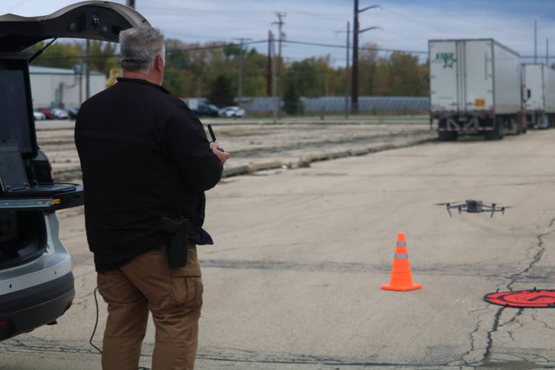 DeKalb Police Department Commander Craig Woodruff lands a drone Oct. 22, 2025, outside the former GE plant in DeKalb.